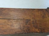 a wooden table with a metal base and a drawer on top of it