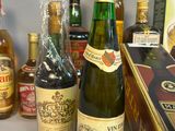 many bottles of wine and liquor on the table