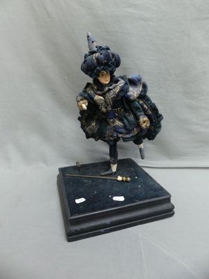 figurine of a woman in a blue dress holding a cane