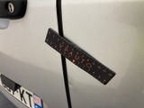 a close up of a car door with a sticker on it ' s side