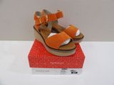 a pair of sandals on top of a red box