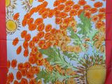 a red table cloth with orange flowers on it