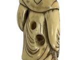 an antique carved ivory figure of a man holding a fish