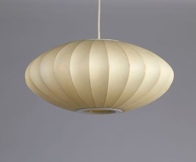 a close up of a white lamp hanging from a ceiling