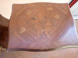 a wooden table with a flower design on it