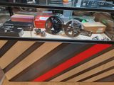 a display case with a bicycle and other items in it