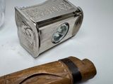 a small wooden box and a lighter on a table