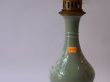 an image of a green vase sitting on top of a wooden stand
