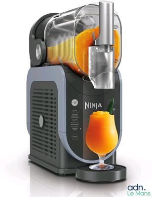 an orange drink being poured into a juicer