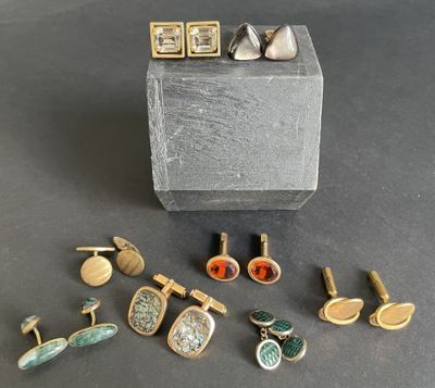 several different types of cuff watches and cuff rings on a black surface