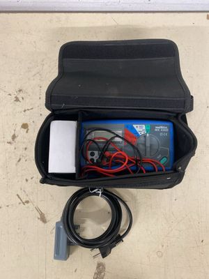 a black case with wires and a charger inside of it