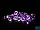 a pile of purple amethtites on a black surface