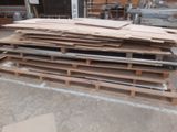 several pieces of wood are stacked on pallets in a warehouse
