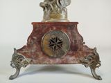 a statue of a woman holding a clock on a stand