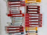 a lot of pens that are sitting on a table