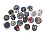 a lot of badges that are on a white surface