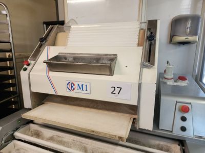 an image of a machine that is making pizzas
