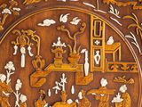 a close up of a wooden panel with a painting on it