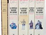 three books are stacked on top of each other on a white surface
