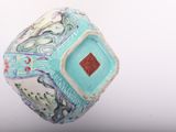 a blue and white vase with a red square in the middle