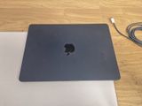 an apple macbook pro laptop sitting on top of a table next to a charger