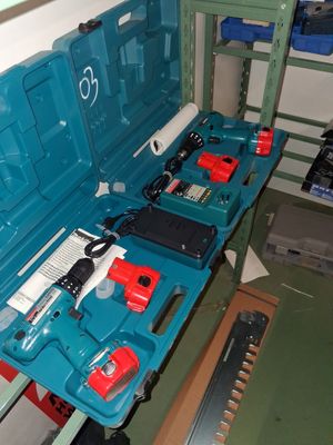 a blue tool box with tools in it on a shelf