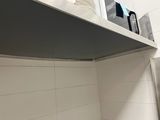 a stack of plates and cups on a shelf in a kitchen