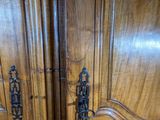 two wooden doors that are open on the side of a building