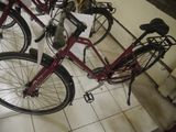 many bicycles that are parked in a room