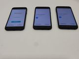 three cell phones are sitting on a table with a white background