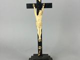 statue of a crucifix on a wooden base with a cross