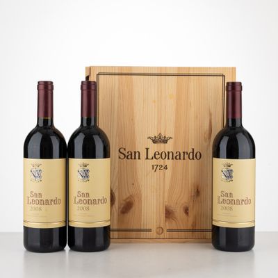 three bottles of wine in front of a wooden box on a table