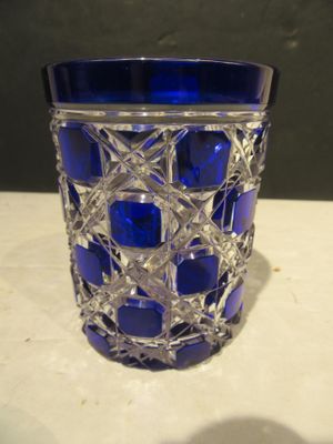 a blue glass vase that is sitting on a table