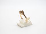 a close up of a gold ring with a diamond on top of it