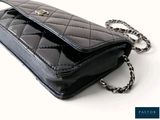 a black purse with a chain hanging from it