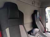 two seats in the back of a truck with a red handle