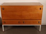 an image of a wooden chest of drawers with metal handles
