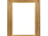 a gold frame on a white wall with a white background