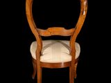 a wooden chair with a white upholstered seat