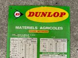 a sign on the side of a building that says dunlop materials, agricoless, roues motries