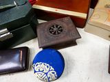 many different types of purses and boxes on the table