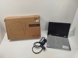 a laptop that is sitting on a table next to a box