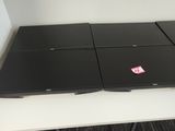 two laptops sitting on top of a white table