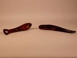 two wooden spoons sitting next to each other on a table