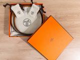 an orange box containing a pair of socks and a pair of gloves
