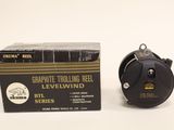an image of a black and gold reel next to a box