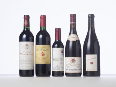several bottles of wine are lined up on a table