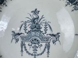 a blue and white plate with a design on it