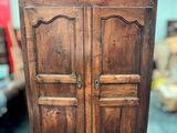 an image of a wooden cabinet with two doors on top of it