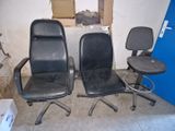 two black office chairs sitting next to each other in a room